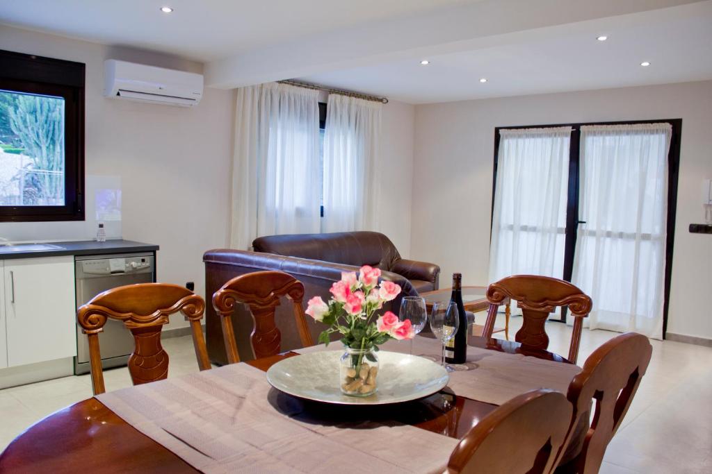 une salle à manger avec une table et un vase de fleurs dans l'établissement Apartamento Centrico en Albir, à Albir