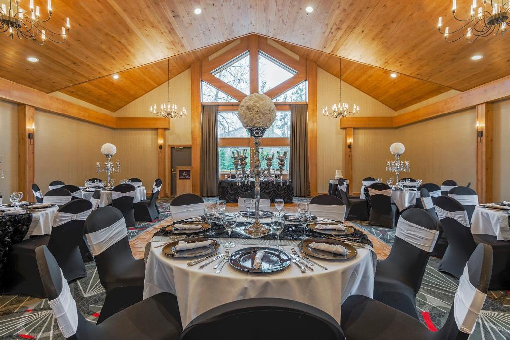 a conference room with tables and chairs and a large window at Banff Rocky Mountain Resort in Banff