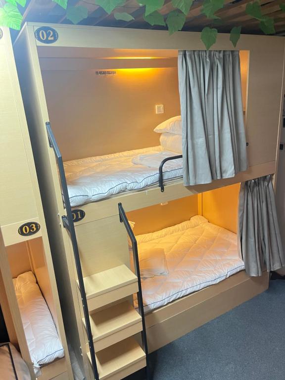 Postel nebo postele na pokoji v ubytování Zhihexing Youth Hostel-知和行青年酒店