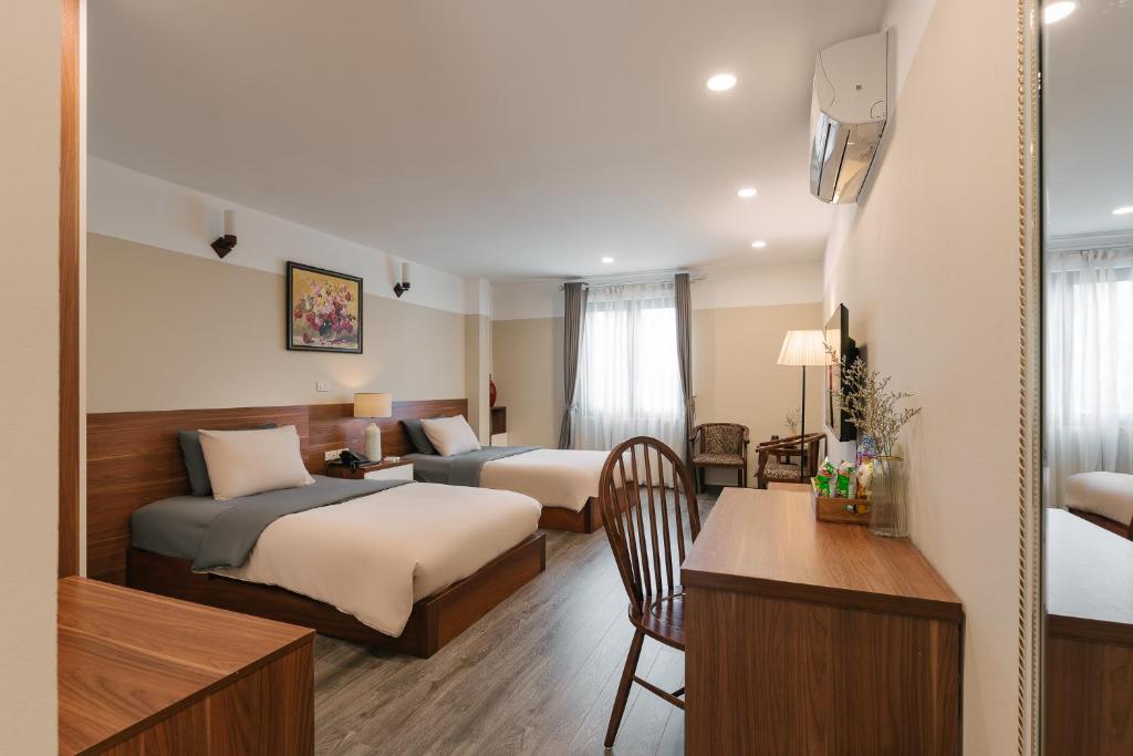Postel nebo postele na pokoji v ubytování An Nguyen Boutique Hotel