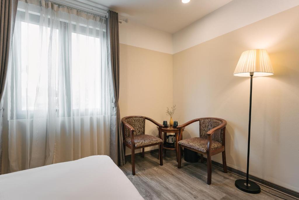 Postel nebo postele na pokoji v ubytování An Nguyen Boutique Hotel