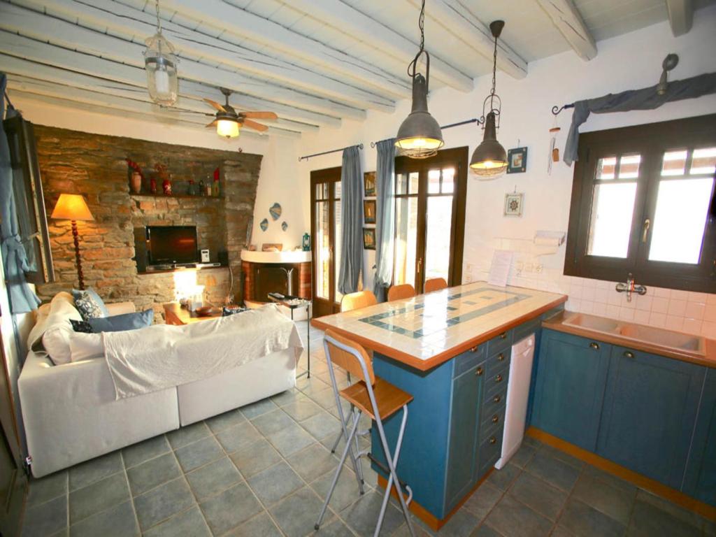 a kitchen and living room with a couch and a table at Stunning seafront apartment in Kea in Korissia