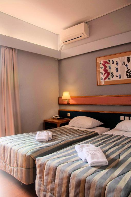 Postel nebo postele na pokoji v ubytování Hotel Samaras