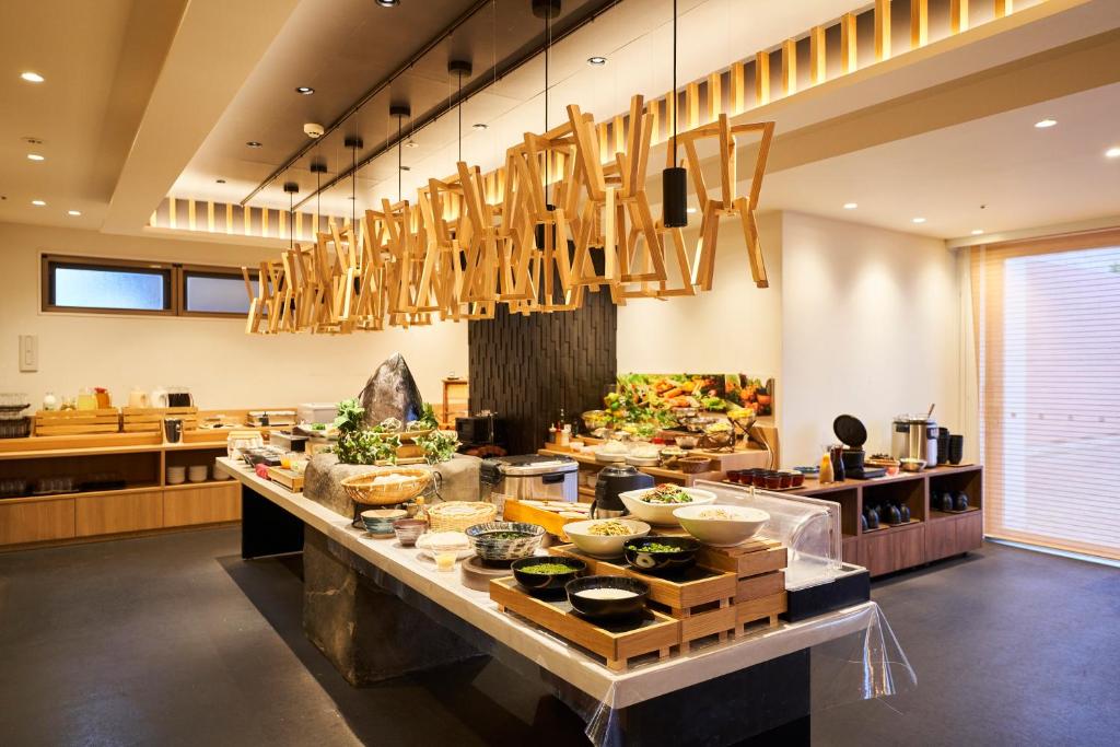 a buffet line in a kitchen with food on it at Hotel Global View Hakodate in Hakodate