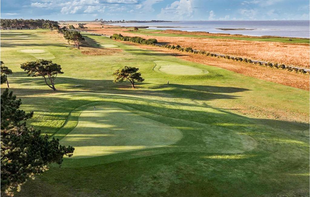 an aerial view of a golf course with the ocean at Amazing Home In Löddeköpinge With Wifi in Löddeköpinge