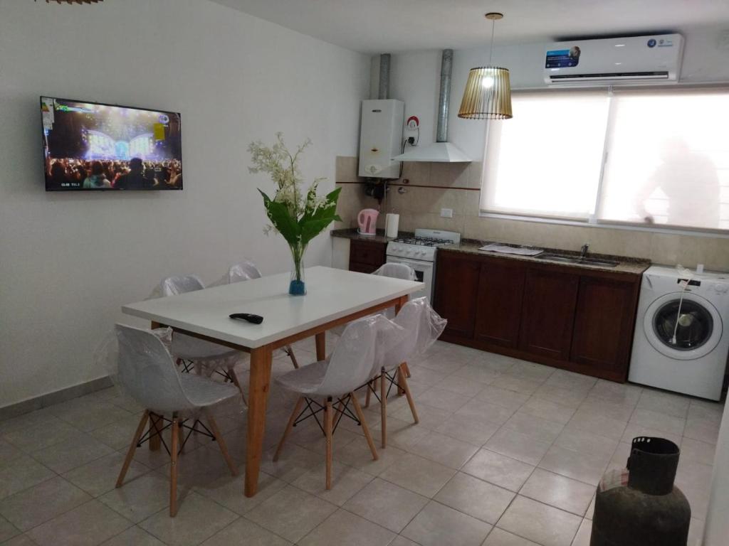 a kitchen with a table with a vase on it at Departamentos Mariano in Cosquín