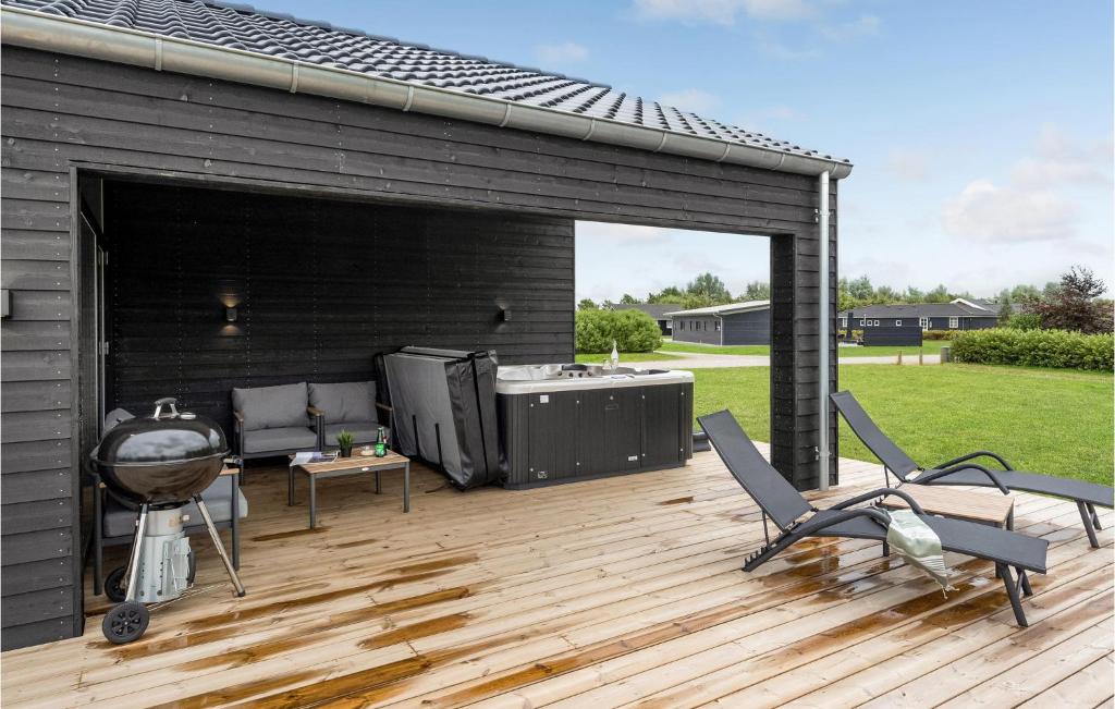 a patio with two chairs and a grill on a deck at 4 Bedroom Beautiful Home In Hemmet in Hemmet