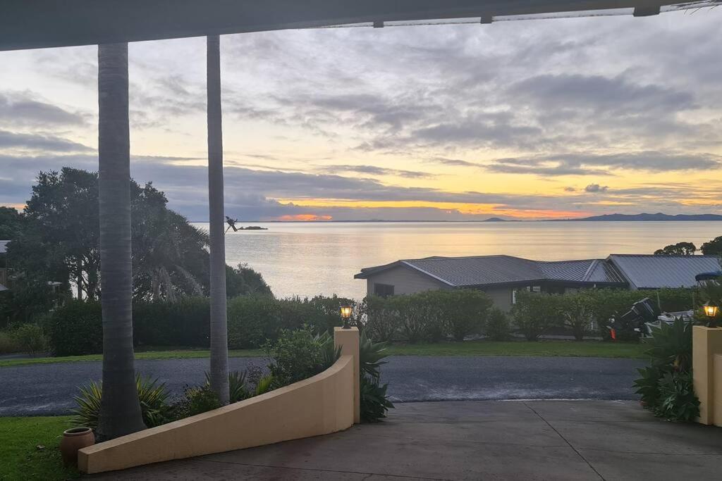 a plane flying over the water with a house at By the Sea 3 bedroom Apartment with ocean views in Coopers Beach