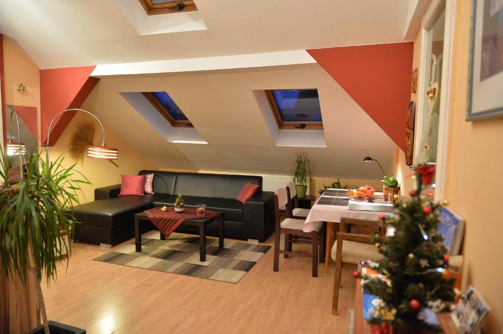 a living room with a christmas tree in a room at Sopron Eszter Apartman in Sopron