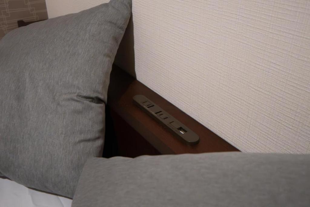 Postel nebo postele na pokoji v ubytování Ja旅 弁天町