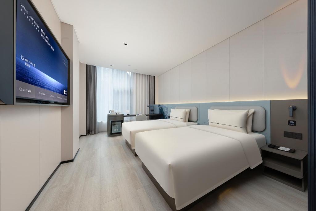 Postel nebo postele na pokoji v ubytování Atour Light Hotel Guangzhou Taikoo Hui Grand Plaza