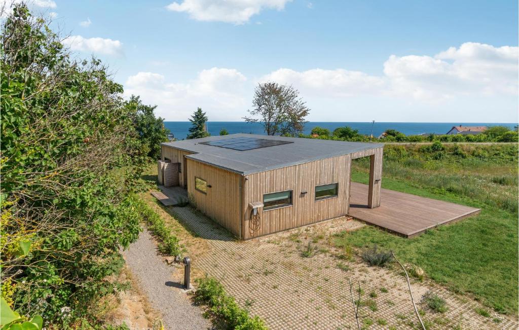 a small house with a deck in a field at 4 Bedroom Beautiful Home In Allinge in Allinge
