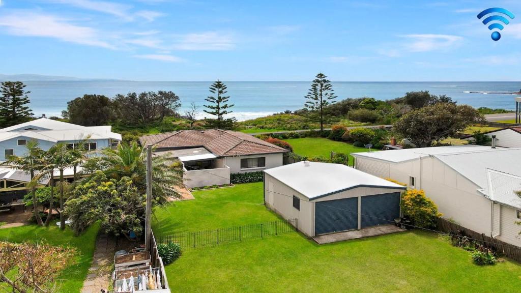an aerial view of a yard with houses and a hot air balloon at Windspray in Culburra Beach