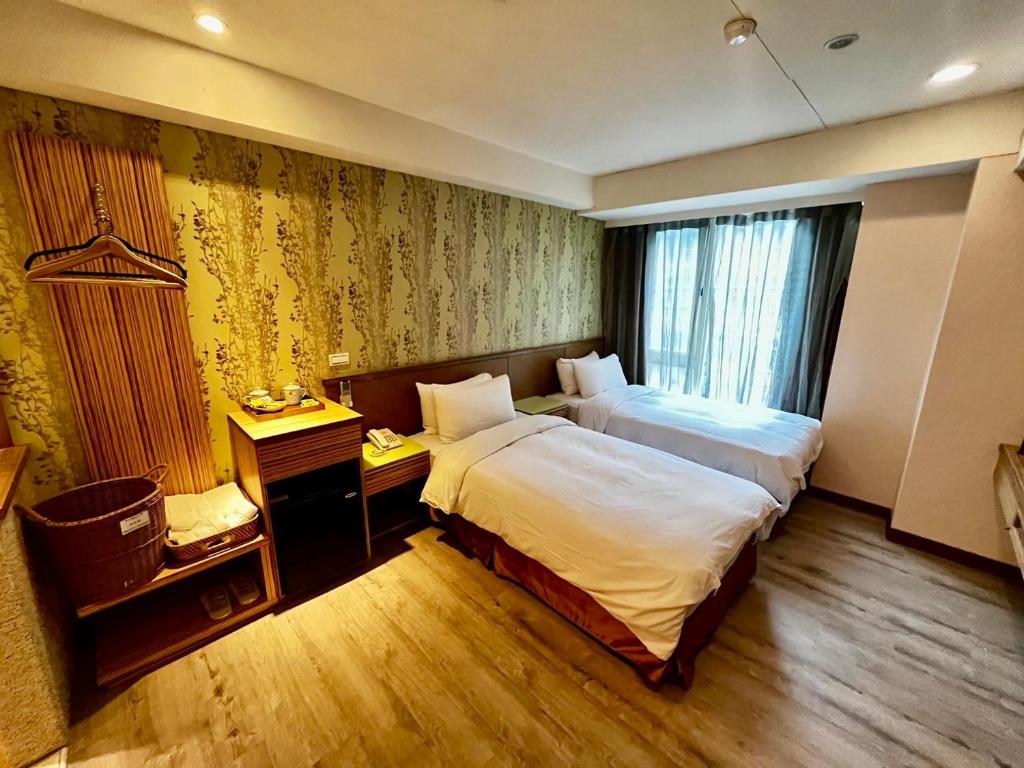 Postel nebo postele na pokoji v ubytování NAGAHIRO Hotel