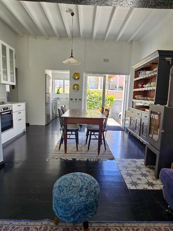 a kitchen with a table and chairs in a room at Majestic Secret in Cape Town