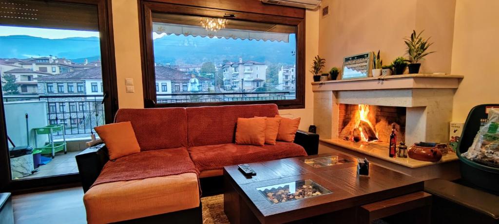 a living room with a couch and a fireplace at Olympus Panorama Luxury Apartment in Litochoro