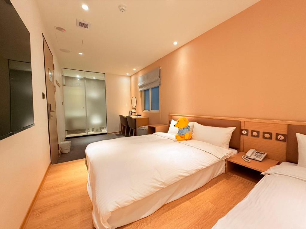 Postel nebo postele na pokoji v ubytování Michi Hotel - Zhongli