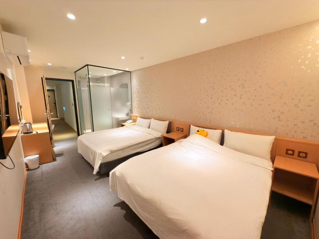 Postel nebo postele na pokoji v ubytování Michi Hotel - Zhongli