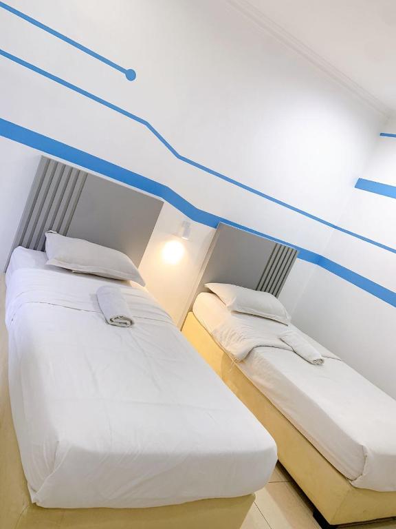 Postel nebo postele na pokoji v ubytování One Stop Hotel Ipoh