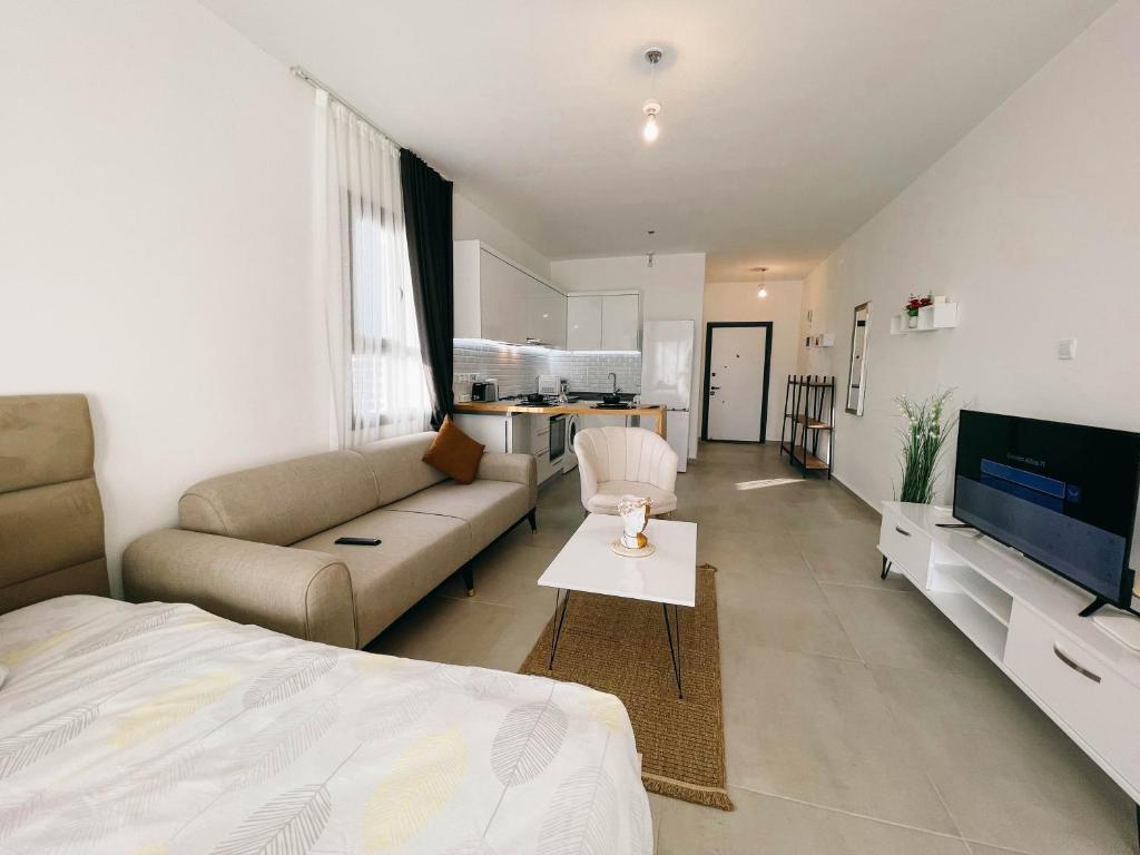 a large living room with a couch and a tv at Luscious Studio in Iskele, Long Beach, Caesar Resort in Trikomo