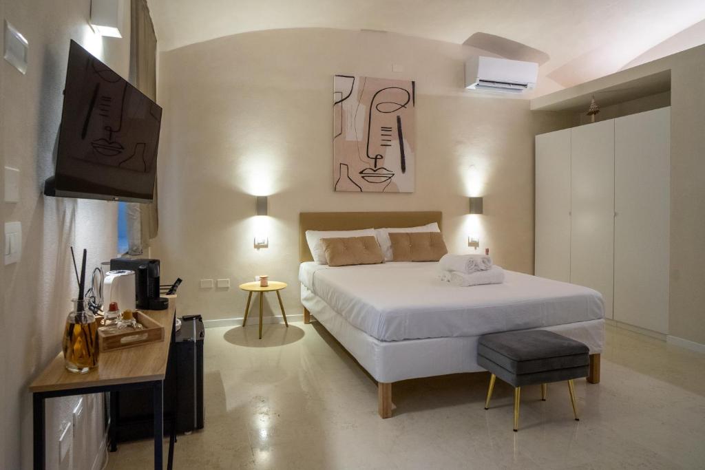 a bedroom with a bed and a television in it at Alle Colonne Luxury Apartments in Verona