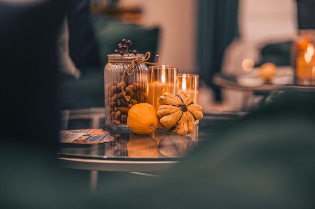a glass table with oranges and candles on it at Arkona Strandresidenzen in Binz