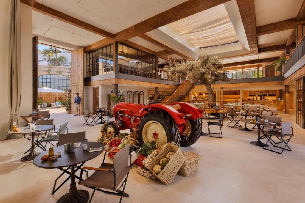 a restaurant with a red tractor in the middle of a room at Six Senses Ibiza in Portinatx
