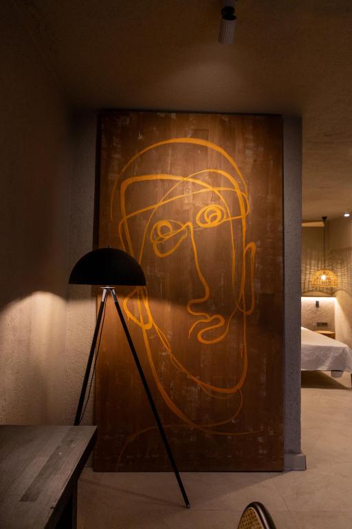 a painting of a face painted on a wall at Sea Soul Hotel in Bodrum City