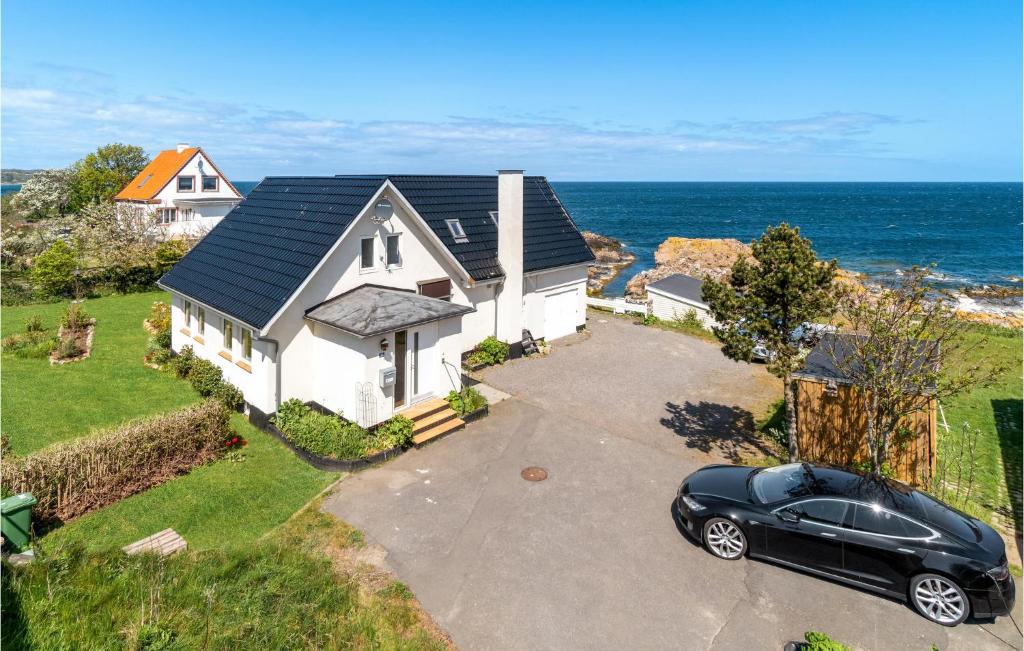 a black car parked in front of a house at Gorgeous Home In Allinge With Sauna in Allinge
