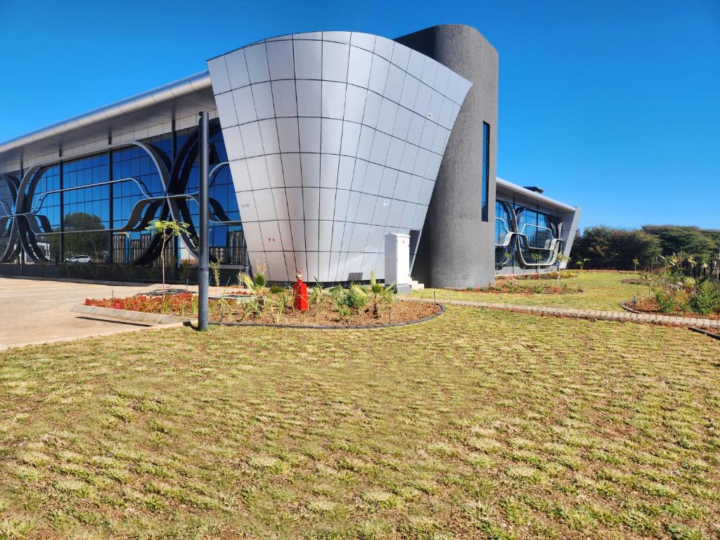 a building with a red fire hydrant in front of it at Cresta Grande Jwaneng in Jwaneng