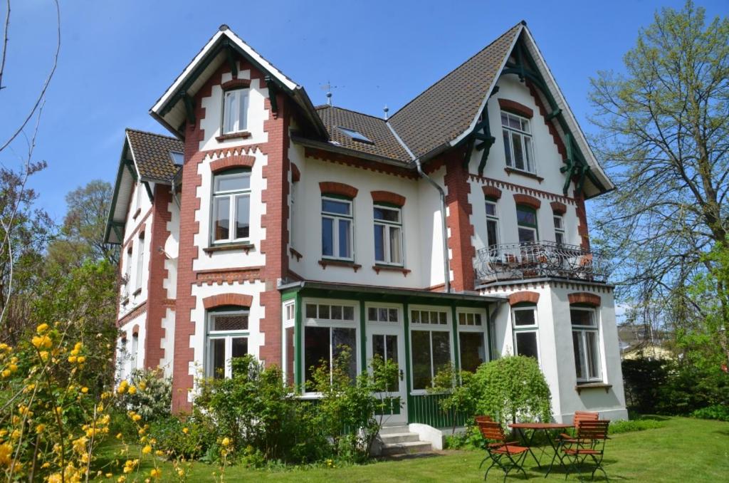 a large house with chairs in the yard at Dahmerhof in Dahme