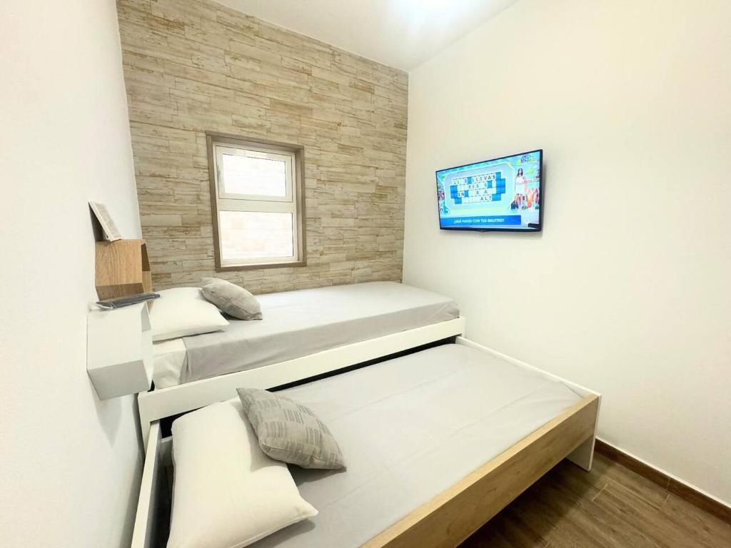 Ein Bett oder Betten in einem Zimmer der Unterkunft Apartamento Rincón del Mar