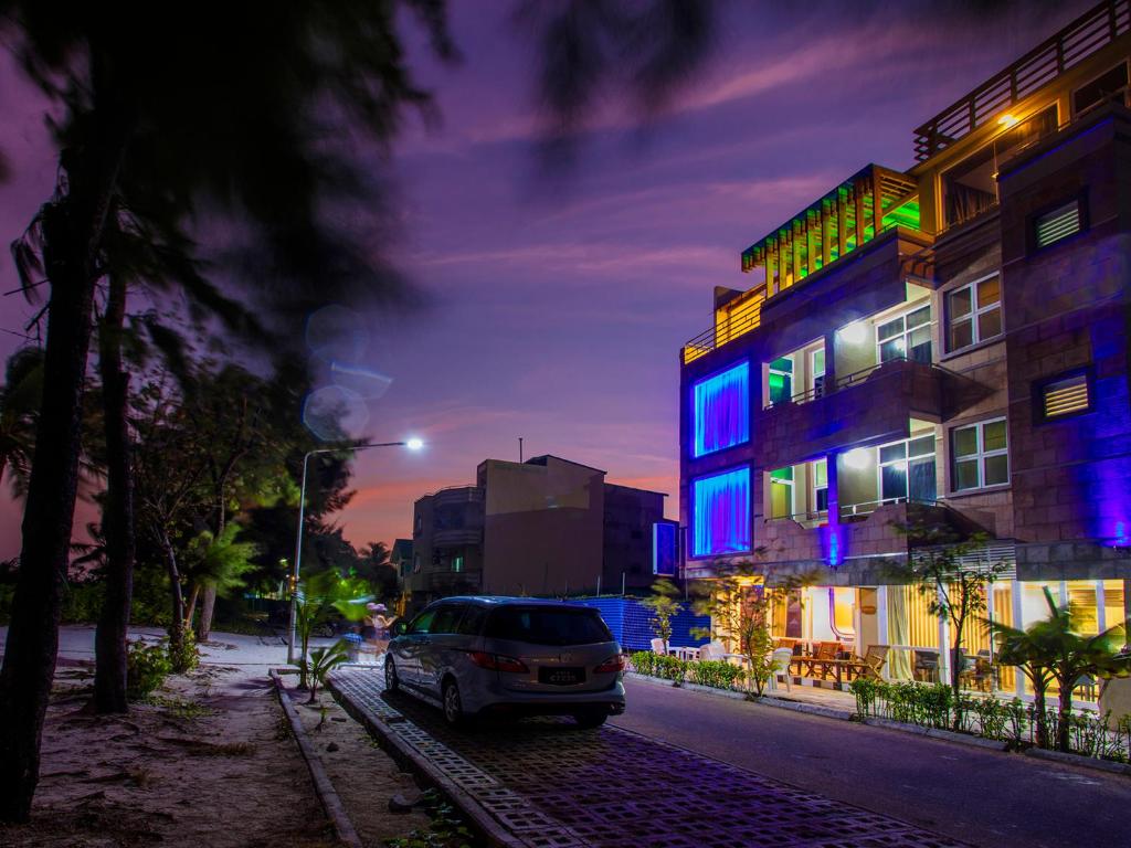 a car parked in front of a building at night at Ripple Beach Inn in Hulhumale