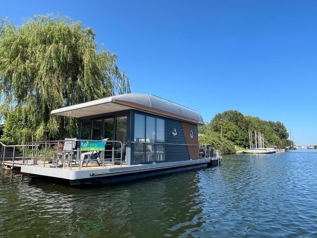 坎珀兰Houseboat Kamperland的河上水面上的船屋