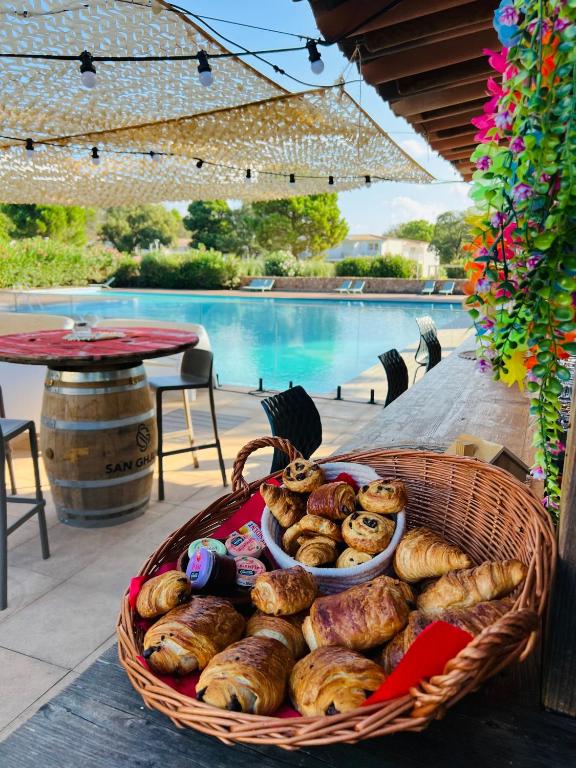 - un panier de pain assis sur une table à côté d'une piscine dans l'établissement Location T2 44 m2 proche plage Lecci appartement 82, à Lecci