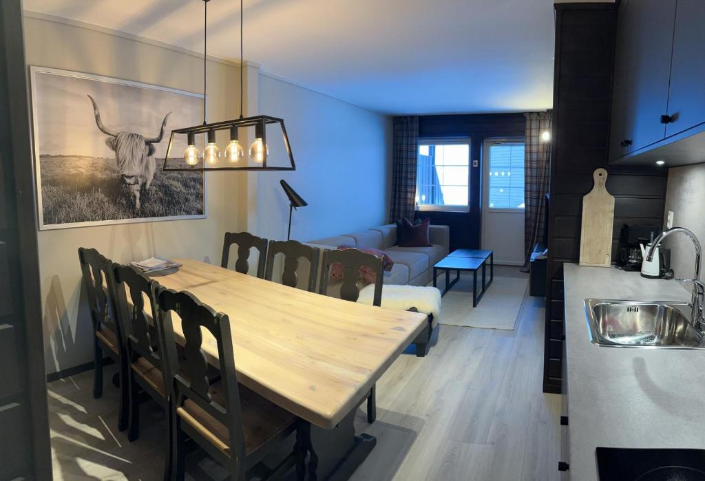 comedor y sala de estar con mesa de comedor en Koselig leilighet på Gautefall, en Drangedal