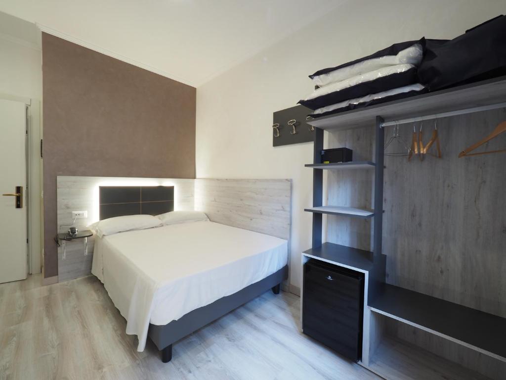 Postel nebo postele na pokoji v ubytování Hotel Osimar
