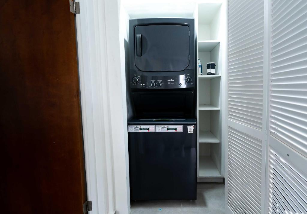 a tv sitting on top of a stove in a closet at The Palms Resort in Saint James