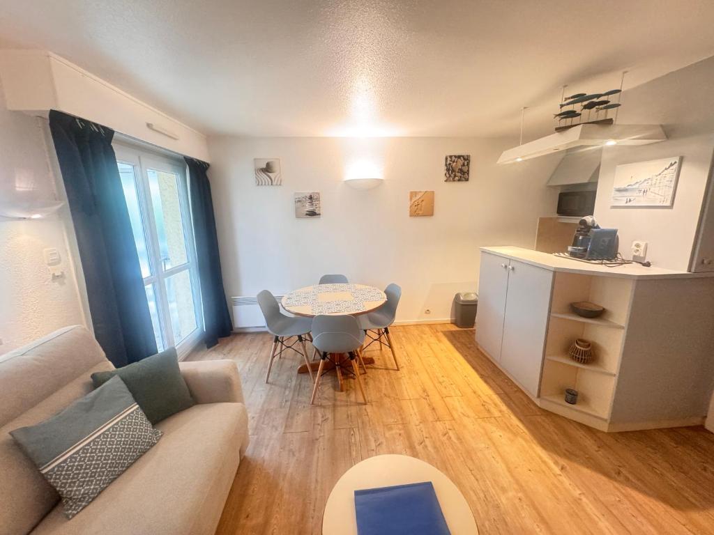 un salon avec un canapé et une table dans l'établissement Studio idyllique et cosy à La Baule - Plage à pied, à La Baule