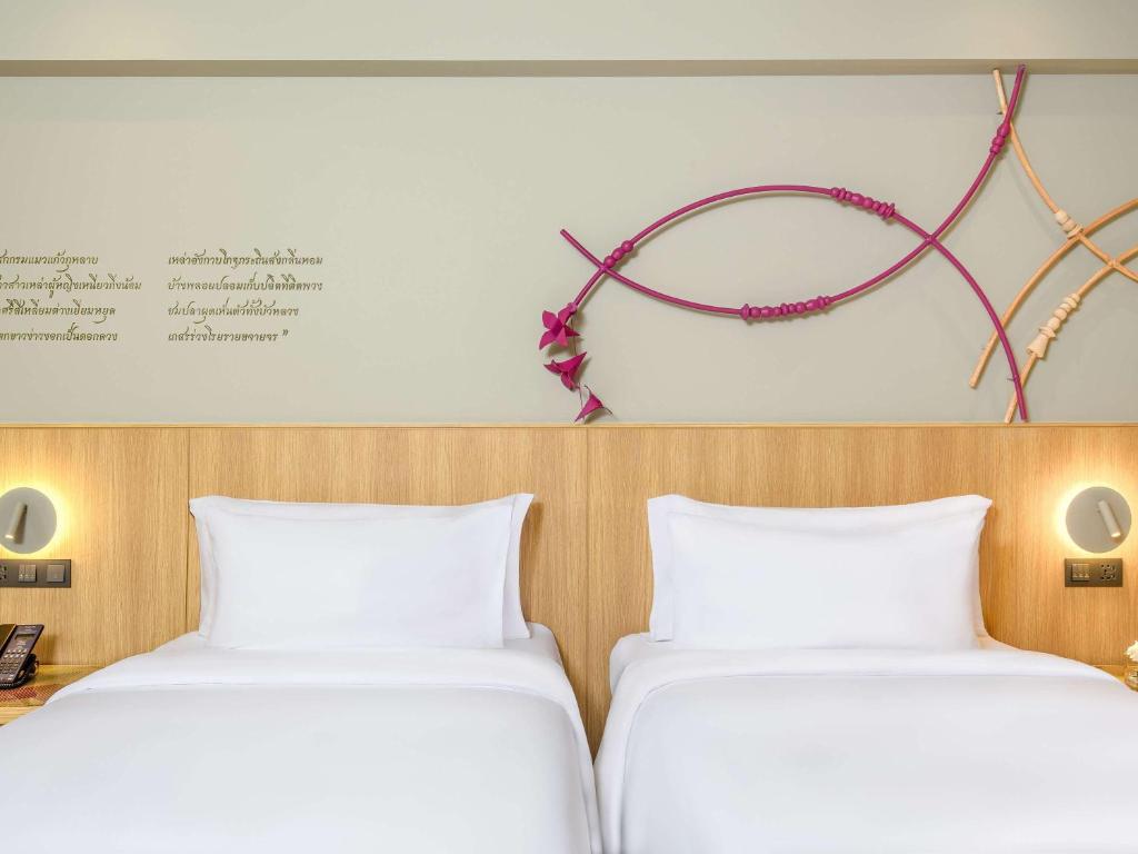 Postel nebo postele na pokoji v ubytování Mercure Rayong Lomtalay Villas & Resort