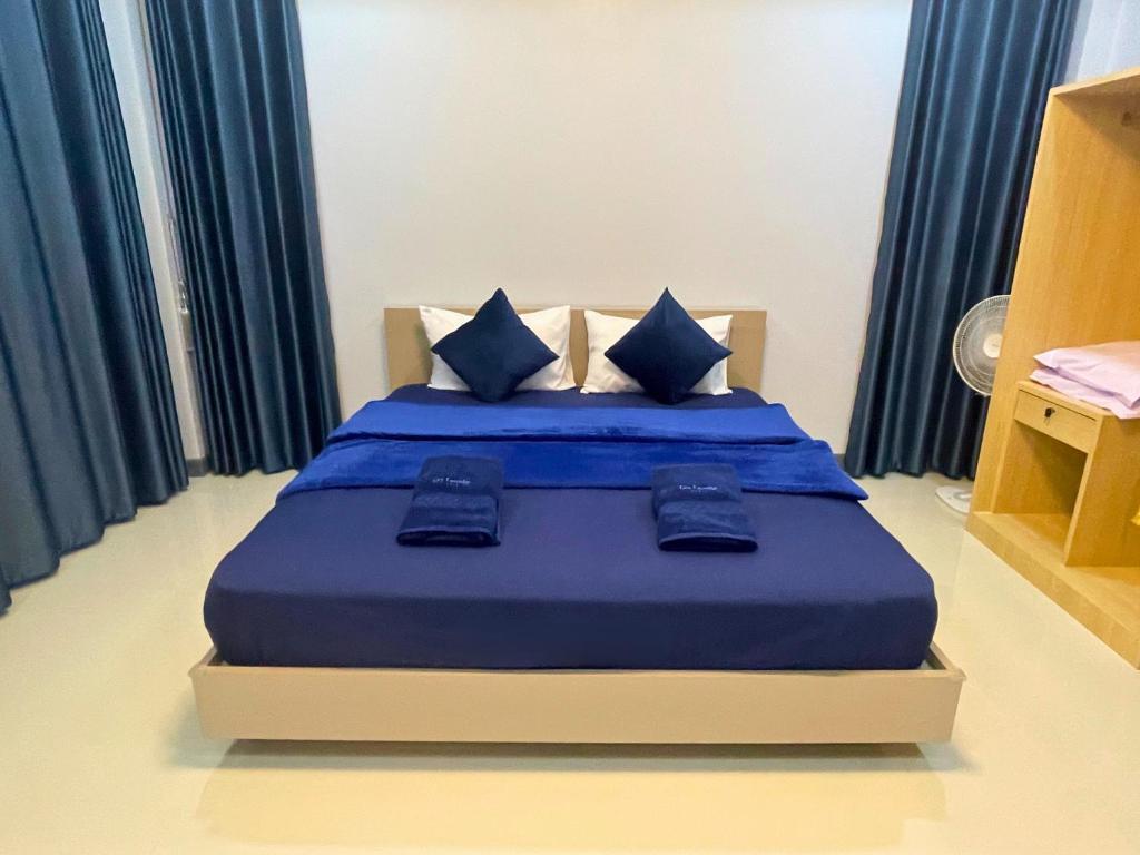Postel nebo postele na pokoji v ubytování IBC Home ที่พักฮาลาล นครศรีธรรมราช