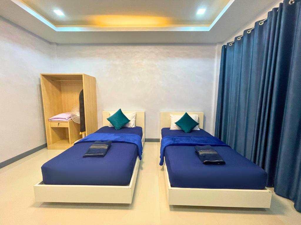 Postel nebo postele na pokoji v ubytování IBC Home ที่พักฮาลาล นครศรีธรรมราช