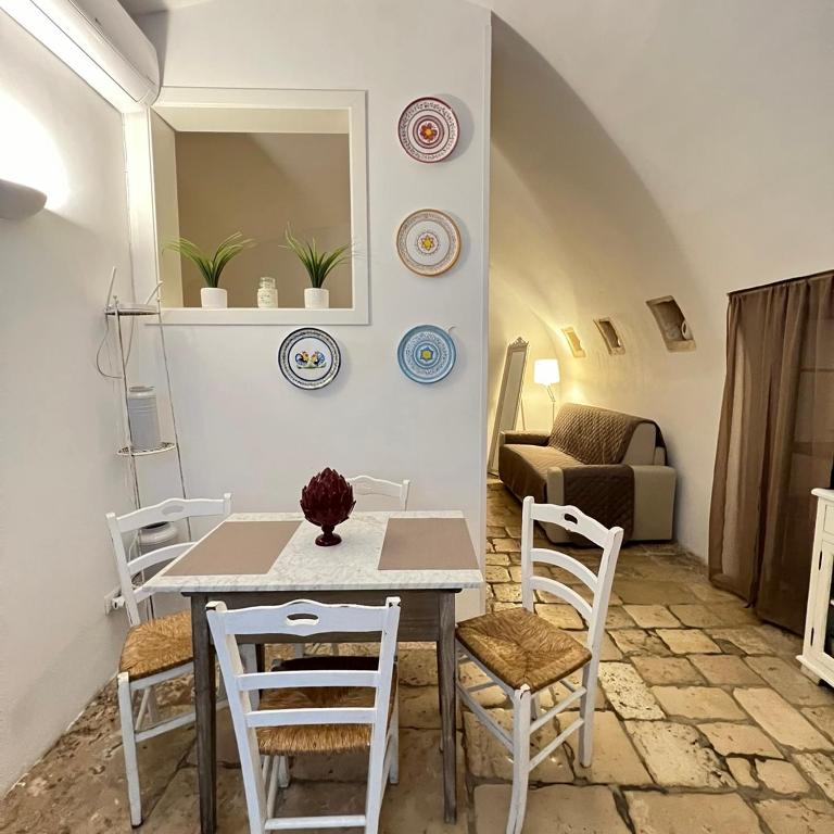 a dining room with a table and chairs at Bari Vecchia Suite in Bari