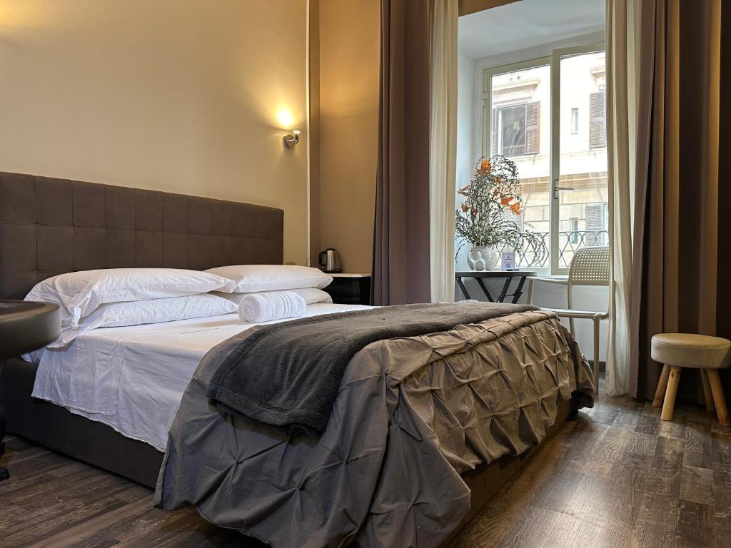 a bedroom with a large bed and a window at Candia Rooms in Rome