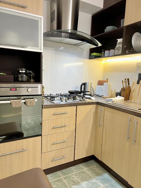 Kuchyň nebo kuchyňský kout v ubytování Cosy Flat