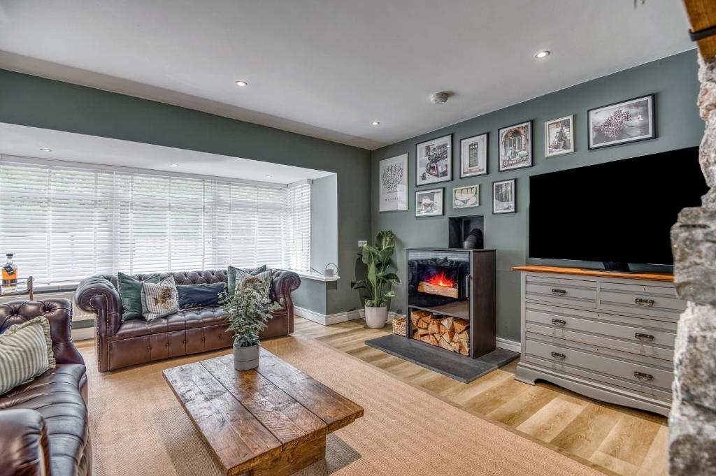 a living room with a couch and a tv and a fireplace at St Marys Hill Chapel in Tenby