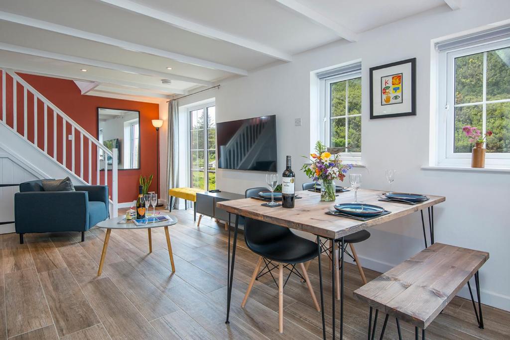 ein Esszimmer und ein Wohnzimmer mit Tisch und Stühlen in der Unterkunft Ty Olwen in Haverfordwest