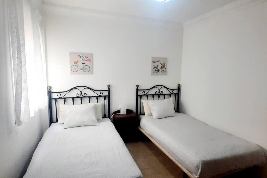 A bed or beds in a room at famara surf wifi 2