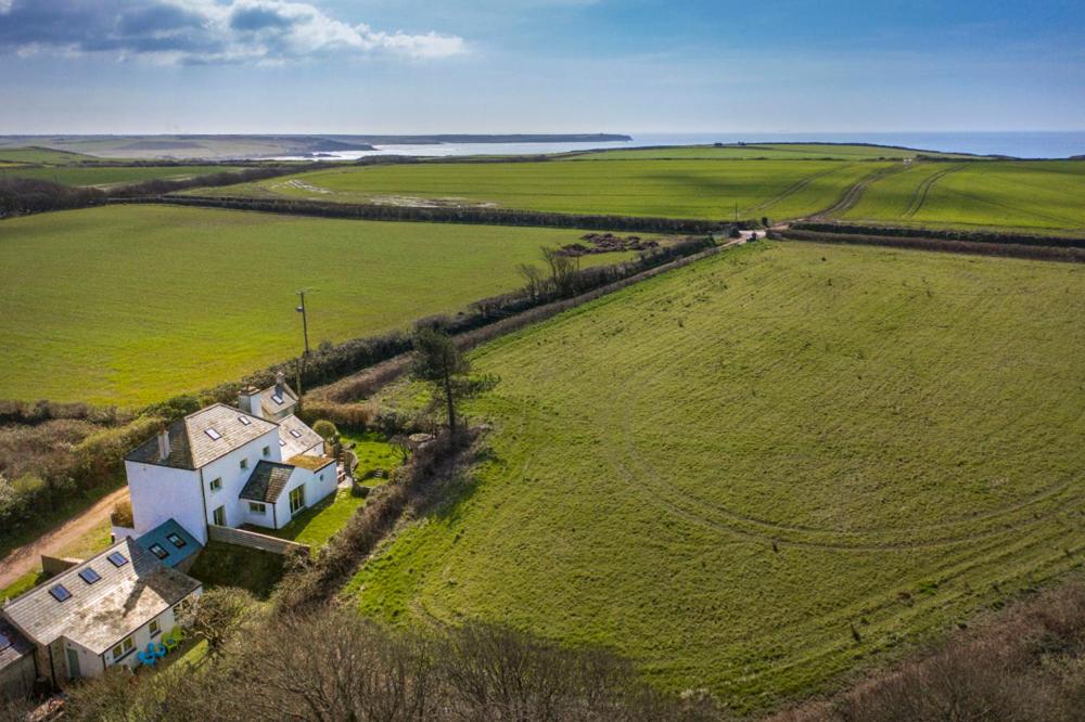 an aerial view of a house in a green field at Bangeston Farmhouse in Pembroke
