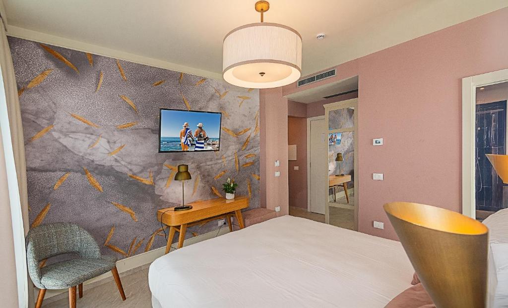 Postel nebo postele na pokoji v ubytování Hotel Mariotti